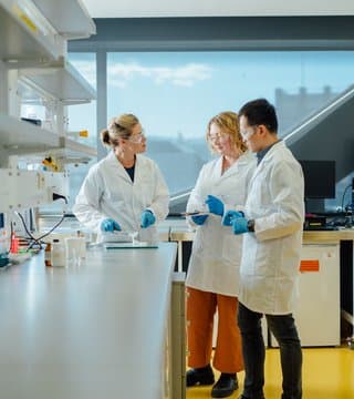 Medical students wearing labcoats in a research laboratory